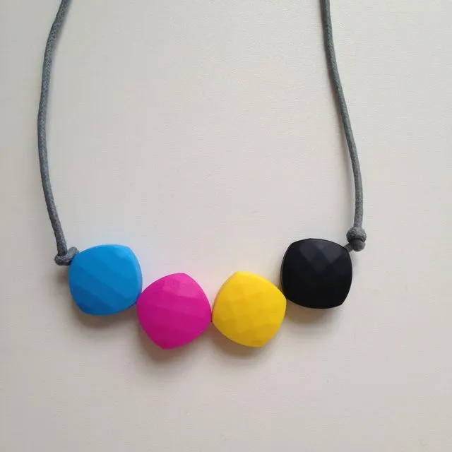 Sky blue, fuchsia, yellow & black (CMYK) quadrate bead teething necklace