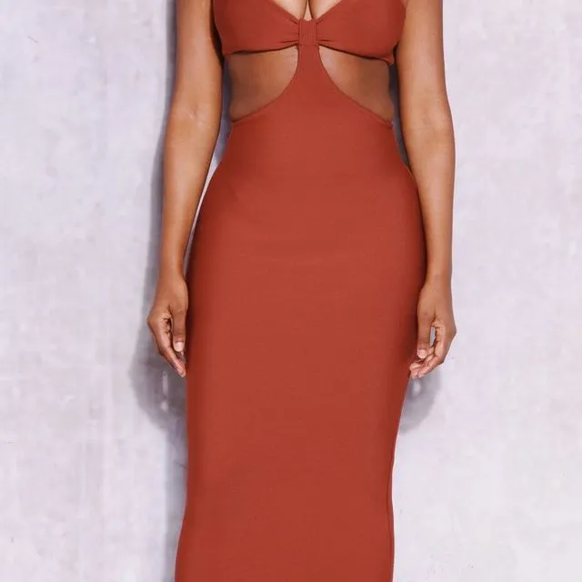 Burnt orange midaxi dress with cut-out detail and spaghetti straps.