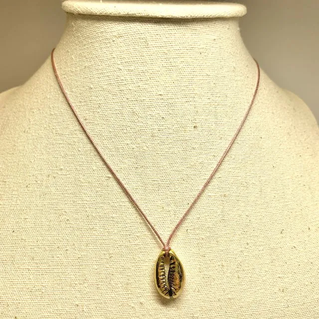 Necklace with a golden metal shell