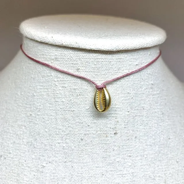 Necklace with a small golden metal shell