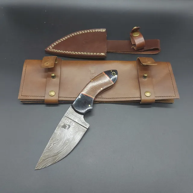 Damascus knife SkollWolf 4.33. Includes anniversary cover for storage and leather cover to attach to the belt. Handcrafted.
