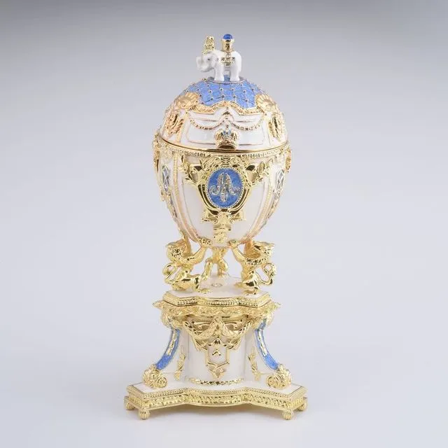White Faberge Egg with an Elephant on Top