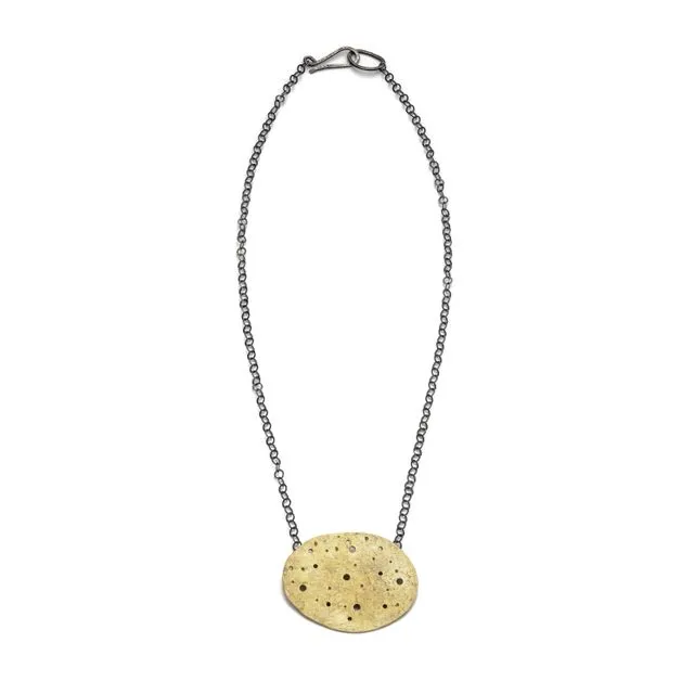 Eroded brass pebble pendant