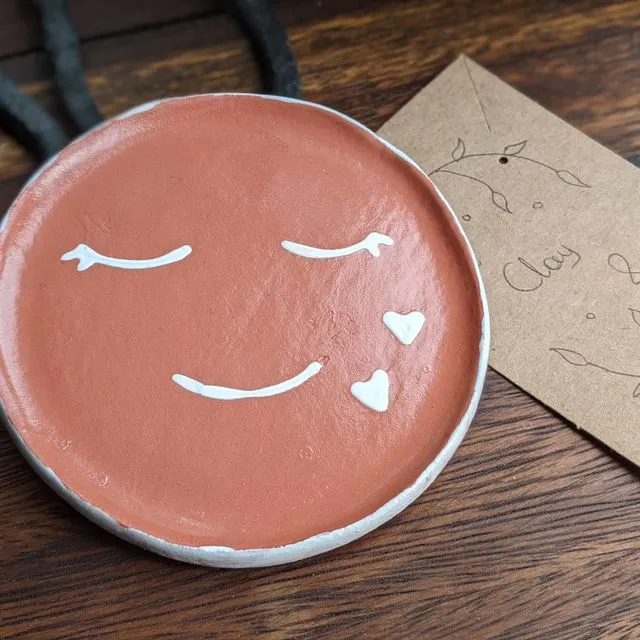 Terracotta clay trinket dish with a white smiley face