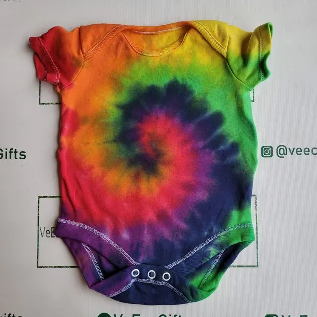 Hand tie dyed rainbow swirl pattern 100% cotton short sleeve baby grow, available in 0 -24 months